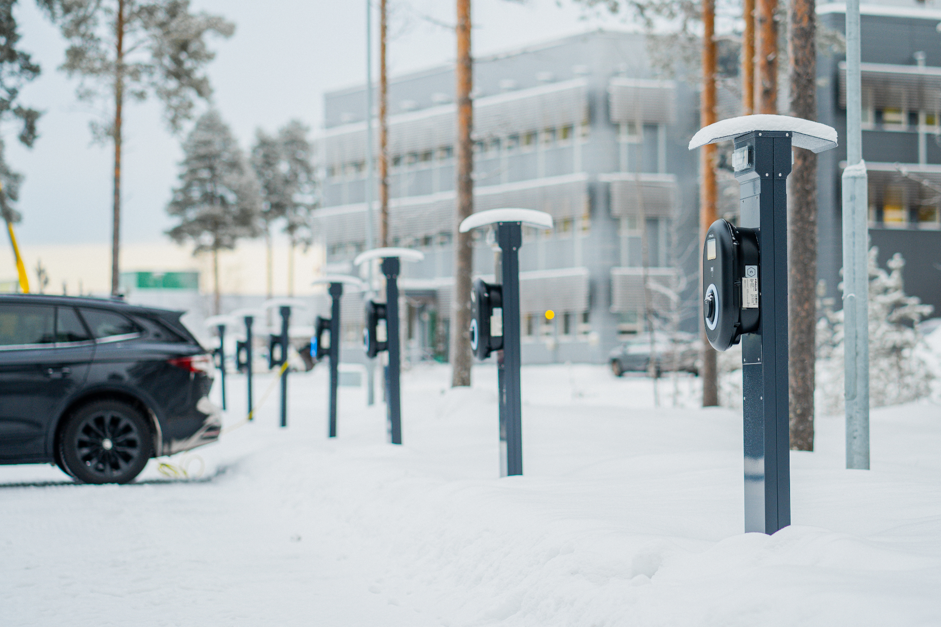Electric vehicle charging stations in a snowy parking area